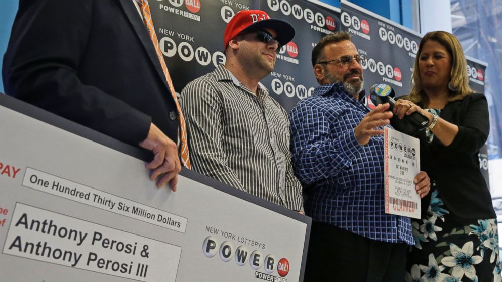 PHOTO: Anthony Perosi, second from right, holding a copy of the winning power ball ticket and his son Anthony Perosi III, second from left, as New York's Lottery Yolanda Vega, right,  presented a prize check, June 4, 2015, in New York.