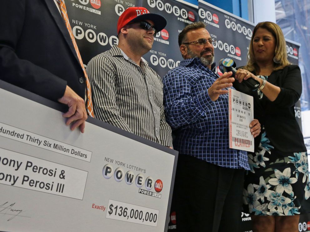 PHOTO: Anthony Perosi, second from right, holding a copy of the winning power ball ticket and his son Anthony Perosi III, second from left, as New Yorks Lottery Yolanda Vega, right, presented a prize check, June 4, 2015, in New York.