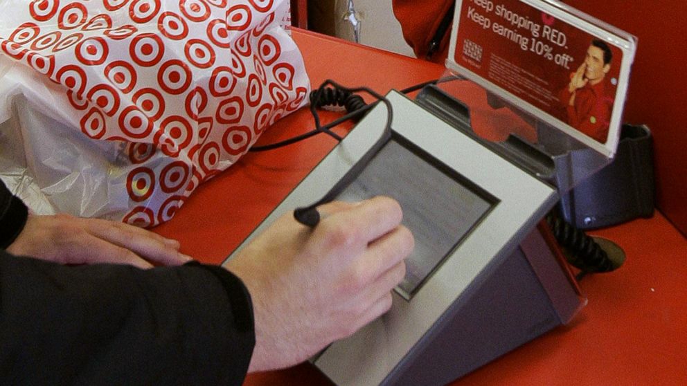 A customer signs on the screen of a credit card machine at a Target store in Tallahassee, Fla., in this Jan. 18, 2008, photo.
