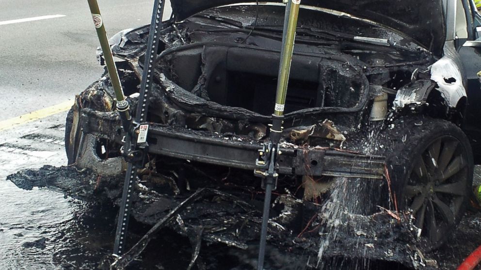 In this Nov. 6, 2013 photo provided by the Tennessee Highway Patrol, emergency workers respond to a fire on a Tesla Model S electric car in Smyrna, Tenn. Spokeswoman Liz Jarvis Shean says Tesla has sent a team to Tennessee to investigate the fire.