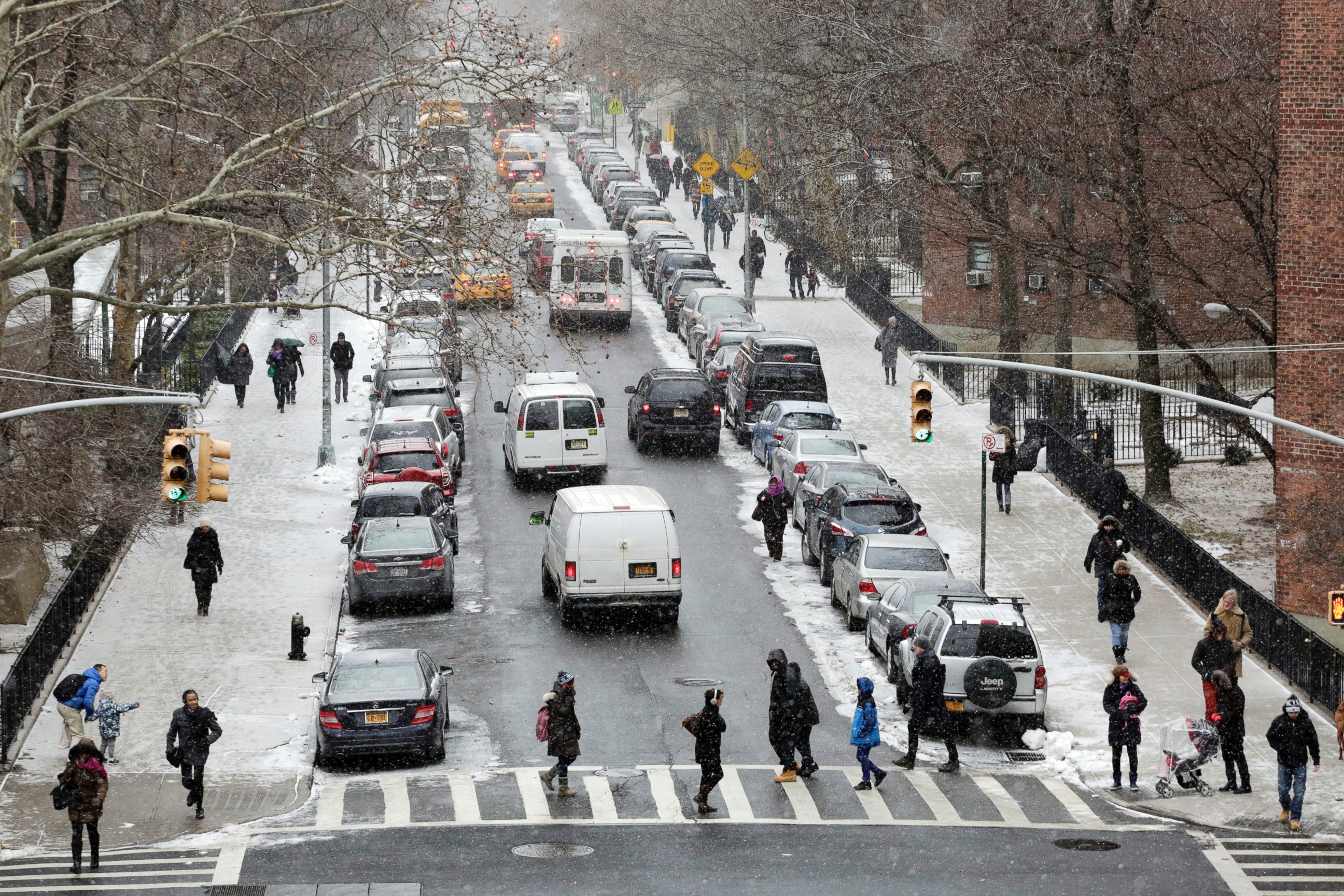 PHOTO: People walk in a light snowfall on Jan. 26, 2015 in New York.