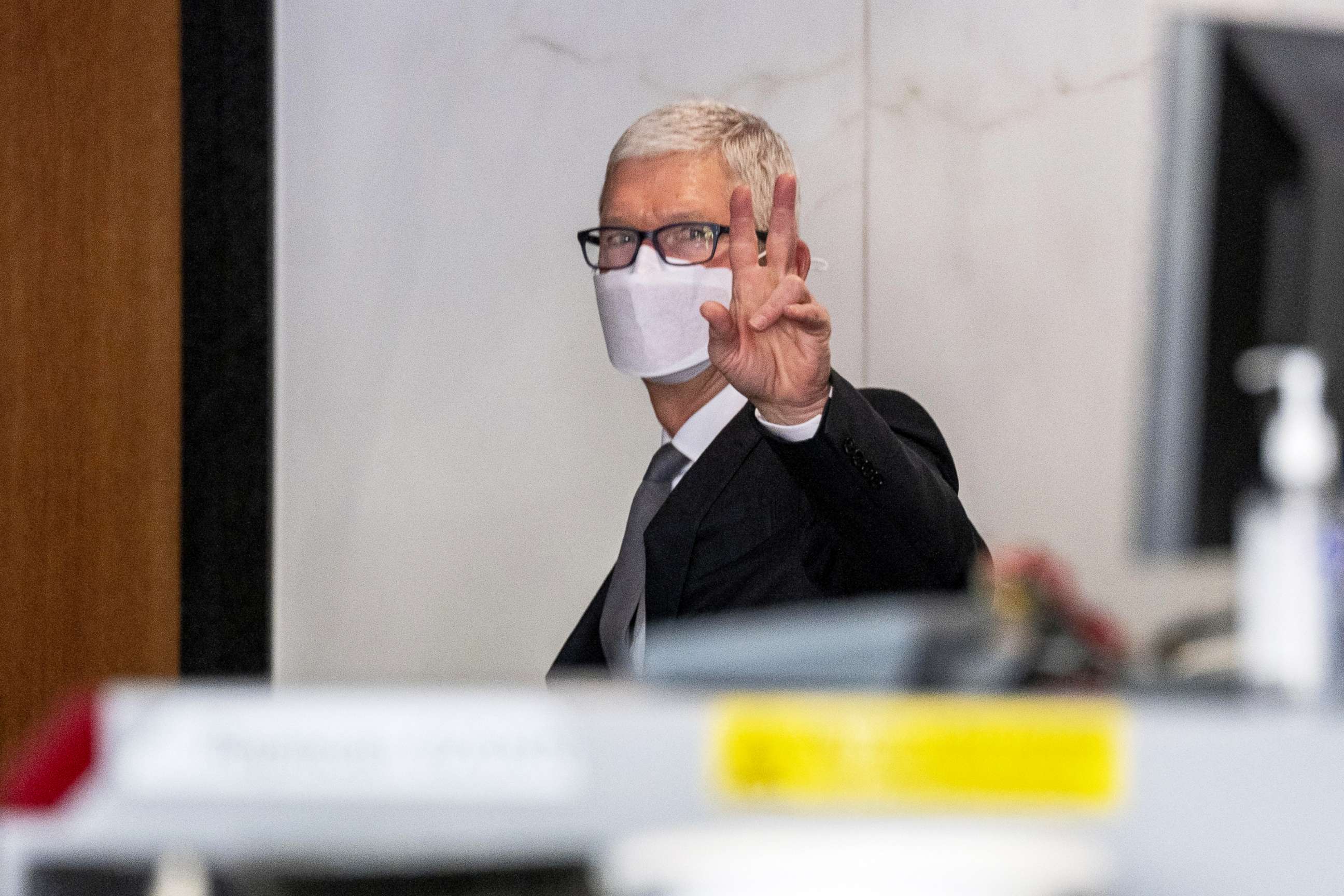 PHOTO: Tim Cook, chief executive officer of Apple Inc., gestures while exiting U.S. district court in Oakland, Calif., May 21, 2021.
