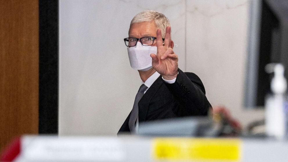 PHOTO: Tim Cook, chief executive officer of Apple Inc., gestures while exiting U.S. district court in Oakland, Calif., May 21, 2021.