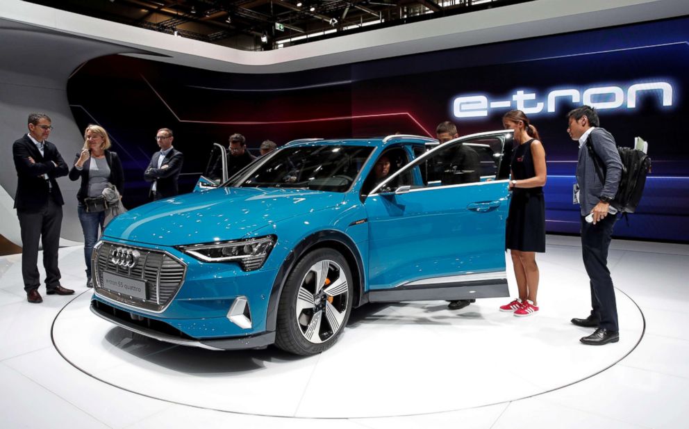 PHOTO: People inspect the Audi E-Tron 5S Quattro during the first press day at the Paris auto show in Paris, Oct. 2, 2018.