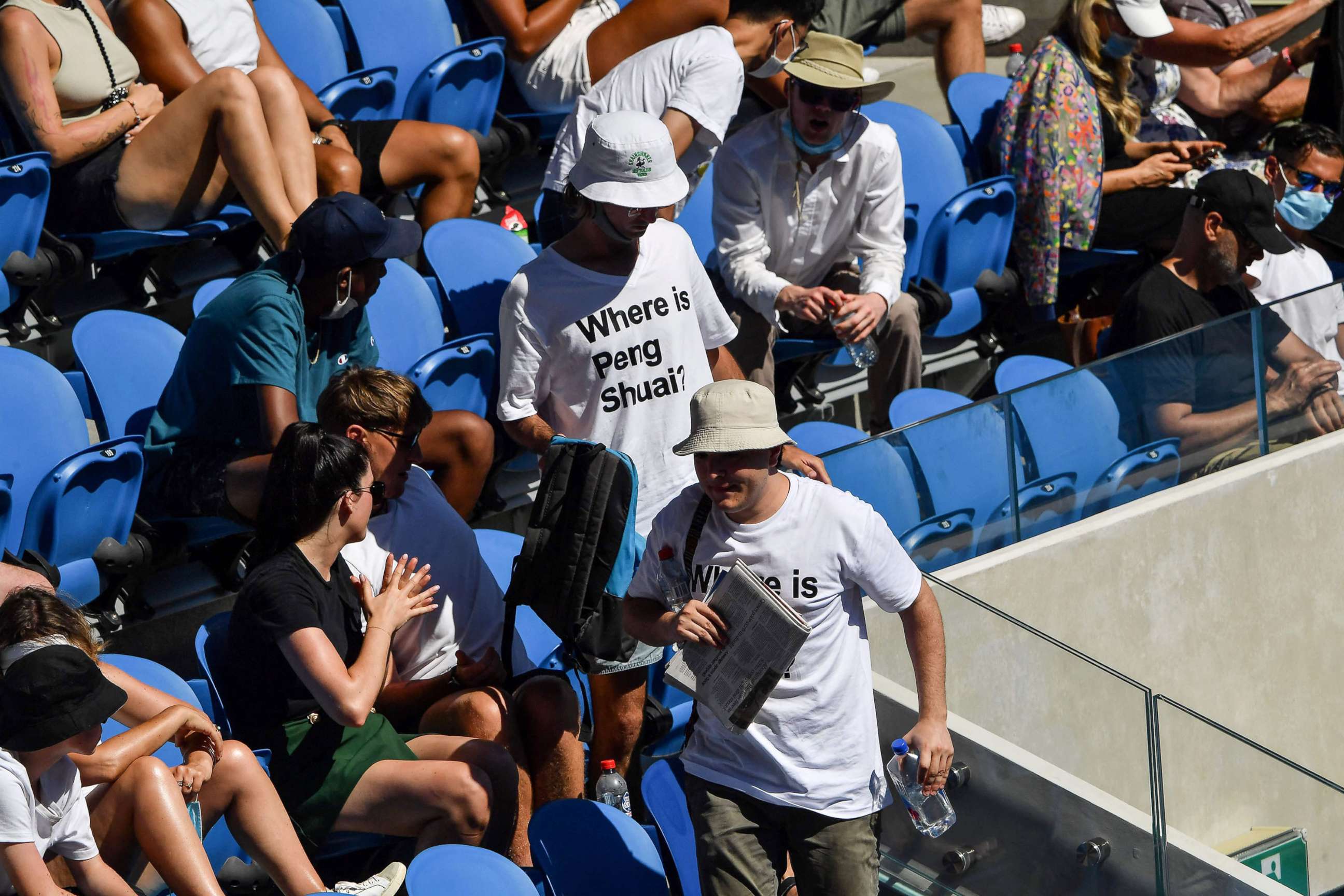PHOTO: Two spectators wearing "Where is Peng Shuai?" t-shirts, referring to the former doubles world number one from China, make their way to seats in the stands on day nine of the Australian Open tennis tournament in Melbourne, Jan. 25, 2022.