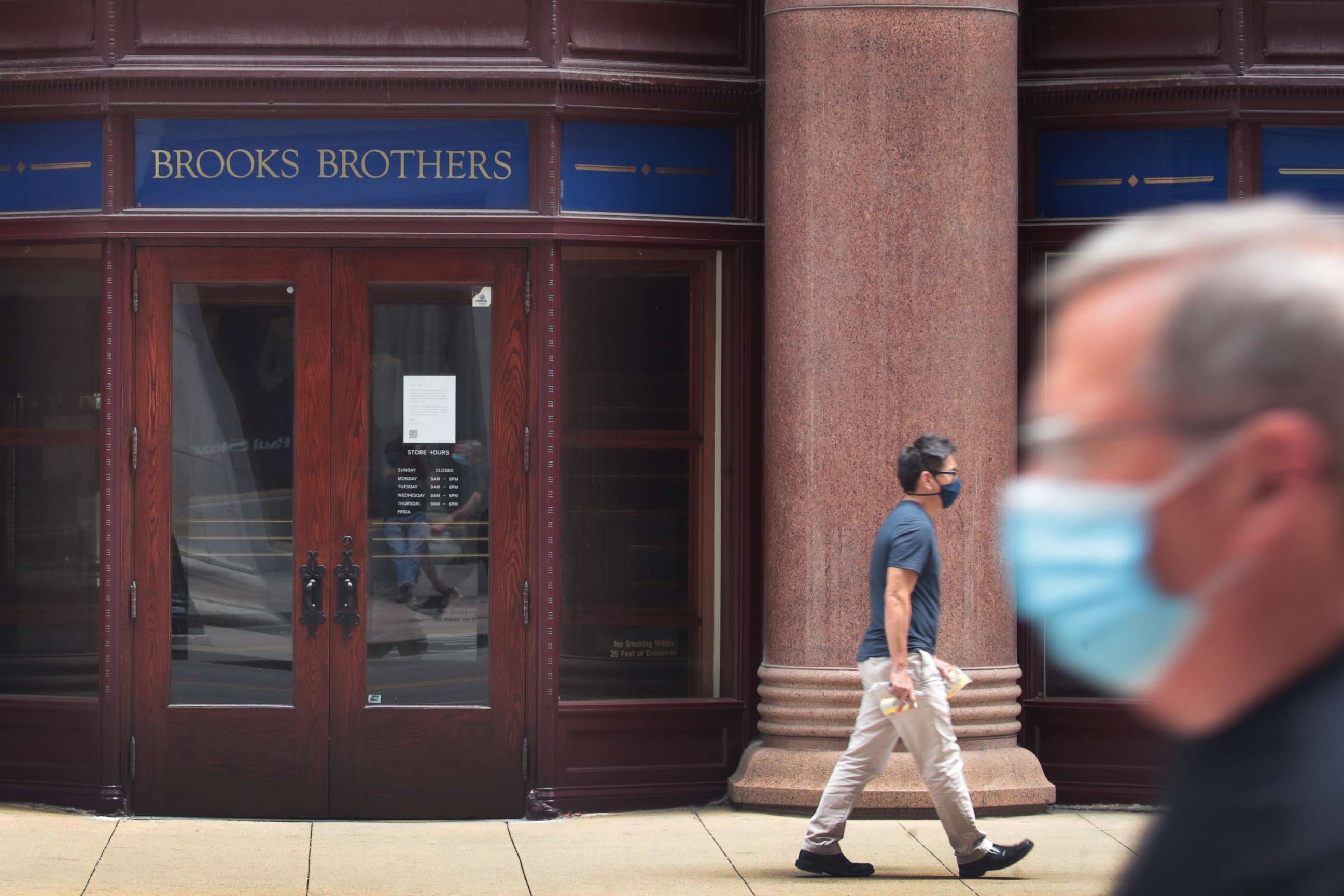PHOTO: A sign hangs above the entrance of a shuttered Brooks Brothers store in the financial district, July 8, 2020, in Chicago.