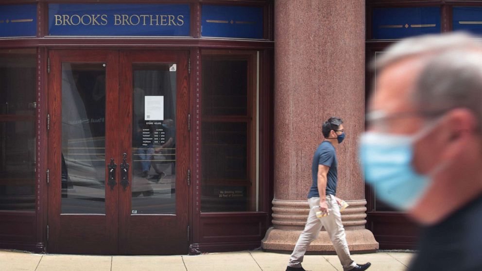 PHOTO: A sign hangs above the entrance of a shuttered Brooks Brothers store in the financial district, July 8, 2020, in Chicago.