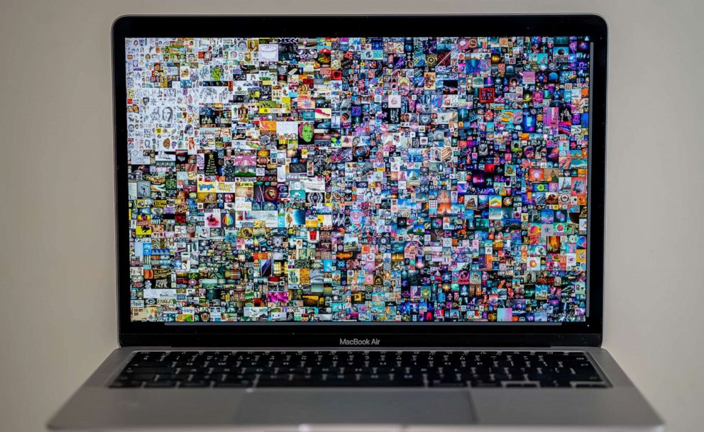 PHOTO: A Macbook Air is shown with Beeple pattern "Everydays: The First 5000 Days" collage art signed with NFT token, in Stafford, England, March 13, 2021.