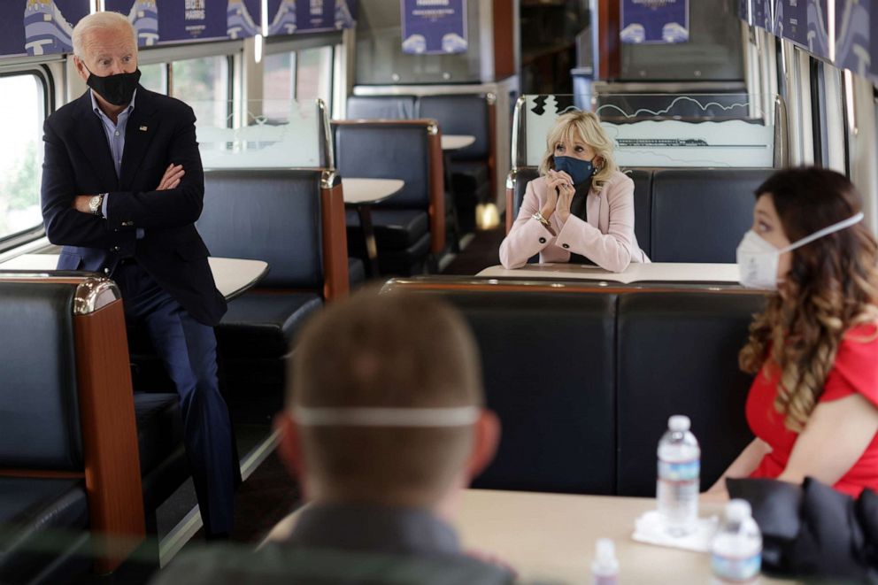 PHOTO: Democratic presidential nominee Joe Biden and wife Dr. Jill Biden listen to supporters on a train campaign tour, Sept. 30, 2020, in Alliance, Ohio.