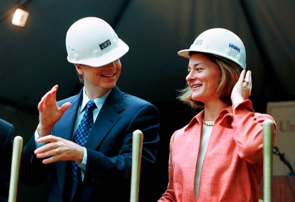 PHOTO: In this file photo taken on May 4, 2001, Microsoft chairman Bill Gates contends with an ill-fitting hard hat while his wife, Melinda Gates, looks on at a groundbreaking ceremony in Seattle.