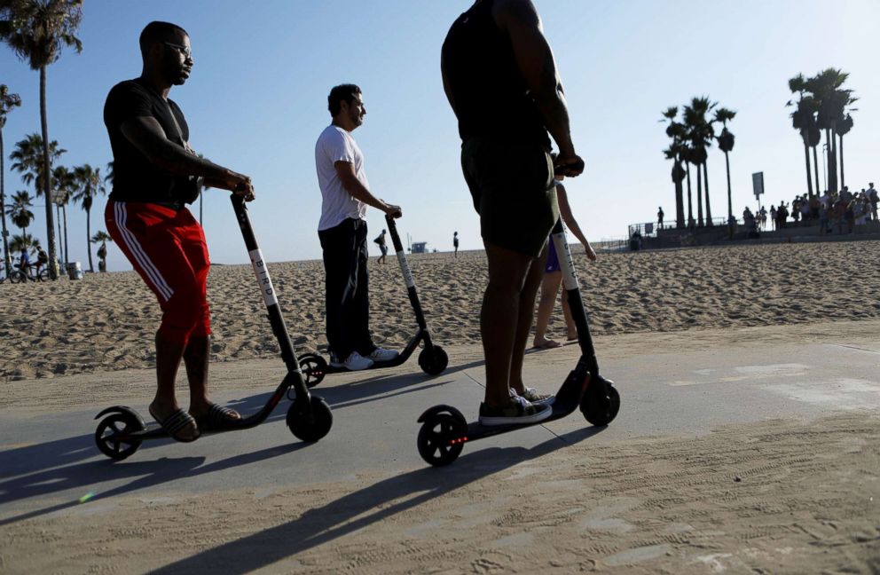 PHOTO: People ride Bird shared dockless electric scooters along Venice Beach, Aug. 13, 2018, in Los Angeles.