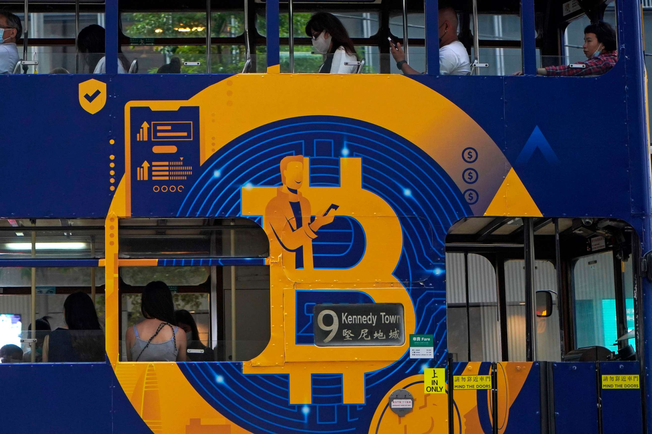 PHOTO: In this May 12, 2021, file photo, an advertisement of Bitcoin, one of the cryptocurrencies, is displayed on a tram in Hong Kong.