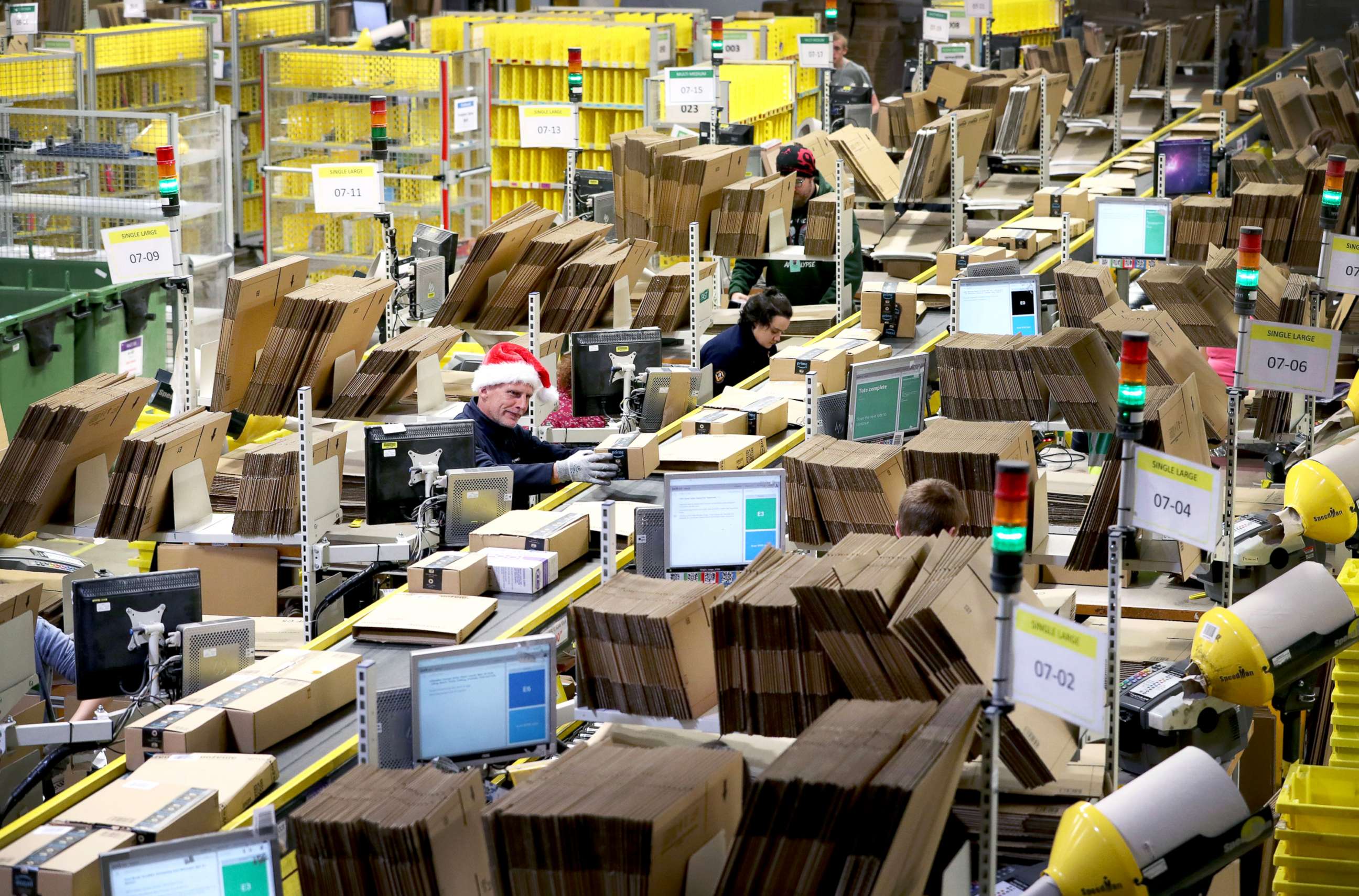 PHOTO: Staff label and package items in an Amazon fulfillment center, as the online shopping giant gears up for the Christmas rush and Black Friday sales.