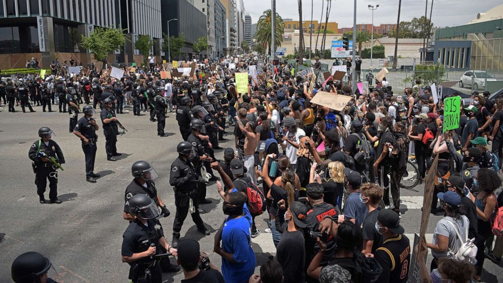 PHOTO: In this June 2, 2020, file photo, protestors gather in front of a row of LAPD officers during a demonstration over the death of George Floyd in Hollywood, Calif.