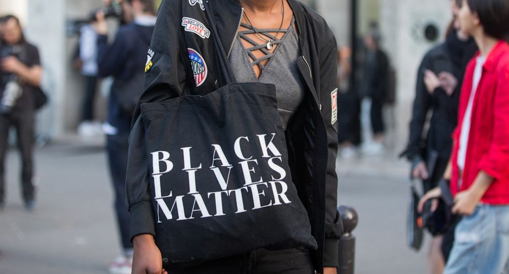 PHOTO: A model carries a "Black Lives Matter" tote bag outside the Rick Owens show at Palais de Tokyo on September 29, 2016 in Paris, France.