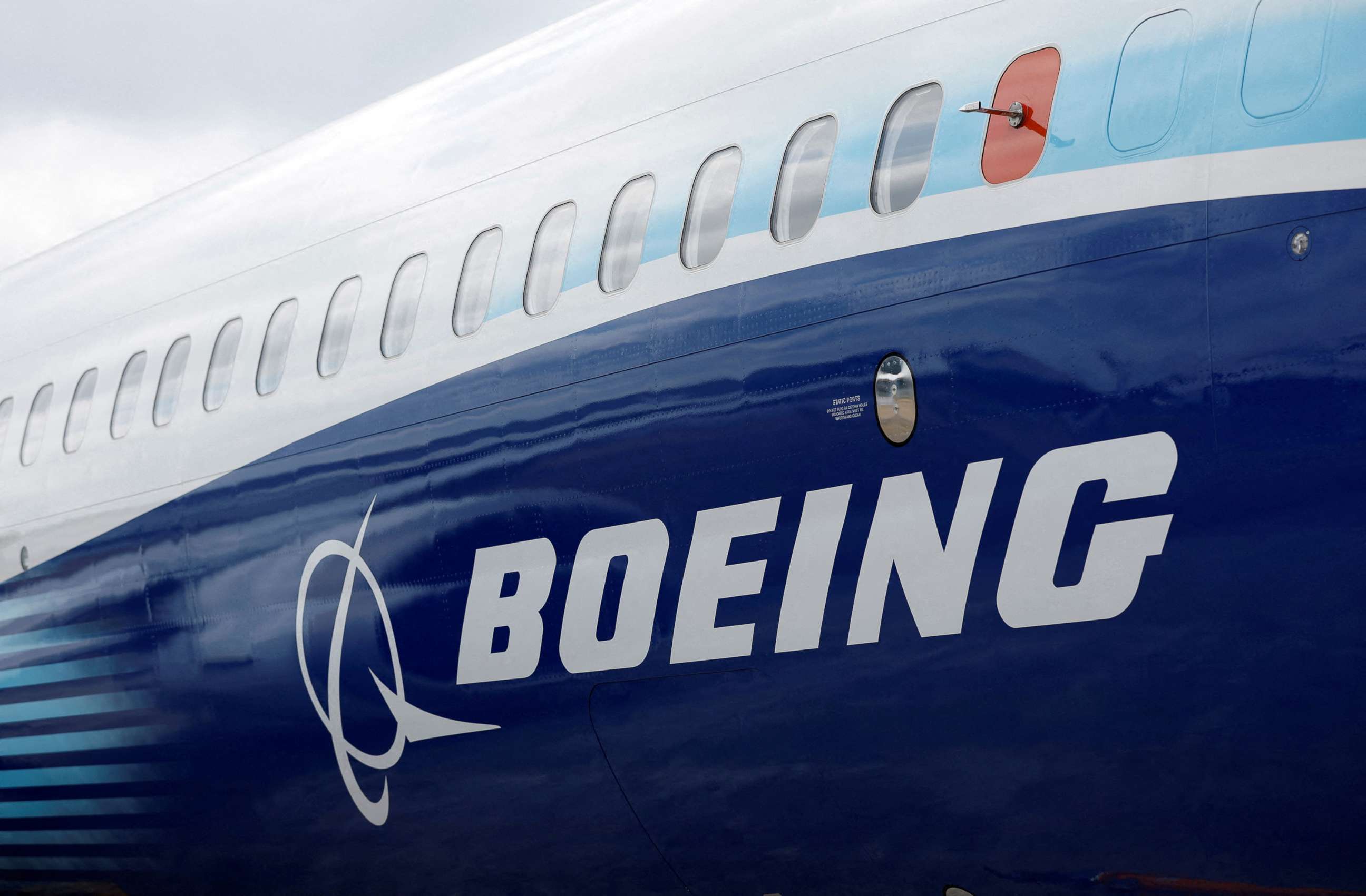 PHOTO: The Boeing logo is seen on the side of a Boeing 737 MAX at the Farnborough International Airshow in Farnborough, Britain, July 20, 2022.