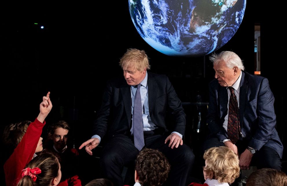 PHOTO: Britain's Prime Minister Boris Johnson (L) sits with British broadcaster and conservationist David Attenborough, during an event to launch the United Nations' Climate Change conference, COP26, in central London on Feb. 4, 2020.