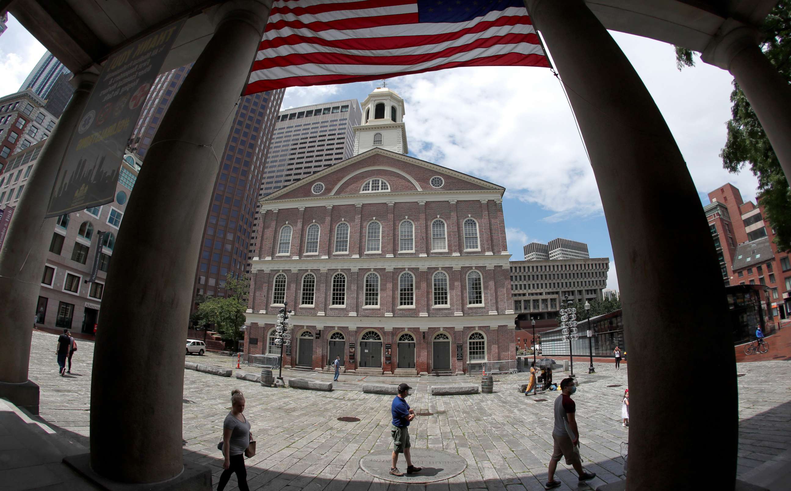 PHOTO: Visitors walk outside Faneuil Hall Marketplace, one of Boston's most popular tourist destinations, as it reopens to the public, Wednesday, July 1, 2020, in Boston.