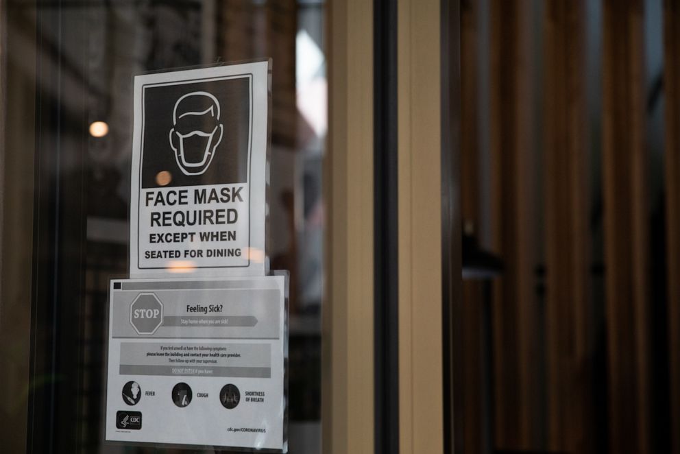 PHOTO: A "Face Mask Required" sign is displayed outside a restaurant in Birmingham, Michigan, June 8, 2020.