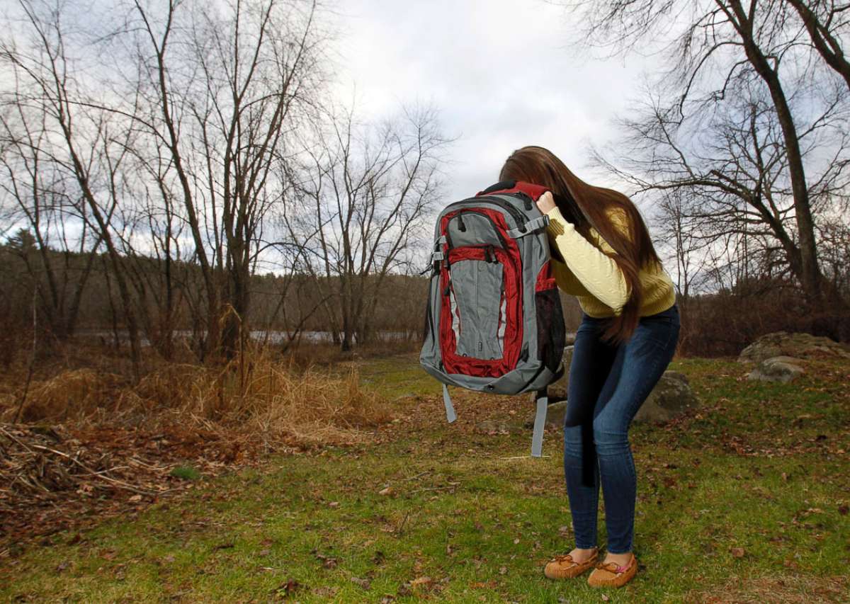 PHOTO: Amanda Curran, 18, daughter of Bullet Blocker inventor Joe Curran, demonstrates how to use a child's bulletproof backpack in the event of a shooting outside of Curran's home in Billerica, Mass. Dec.19, 2012