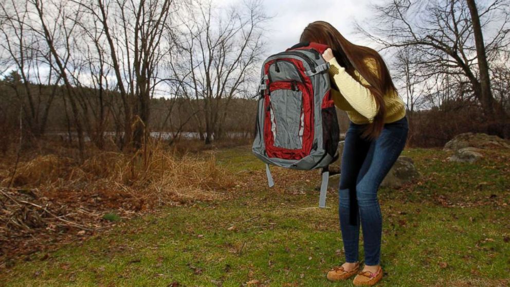 PHOTO: Amanda Curran, 18, daughter of Bullet Blocker inventor Joe Curran, demonstrates how to use a child's bulletproof backpack in the event of a shooting outside of Curran's home in Billerica, Mass. Dec.19, 2012