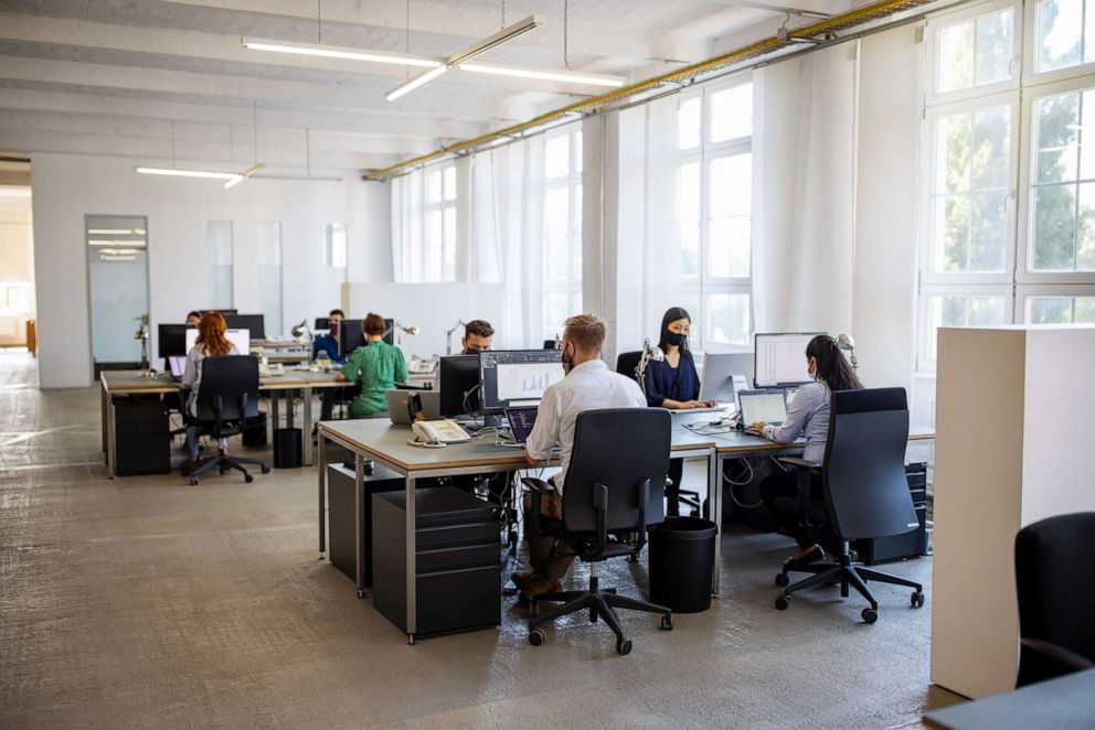 PHOTO: People work in an office in a stock photo.