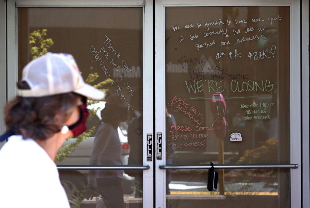 PHOTO: A pedestrian walks by a closed Starbucks Coffee, July 14, 2020, in San Rafael, Calif.