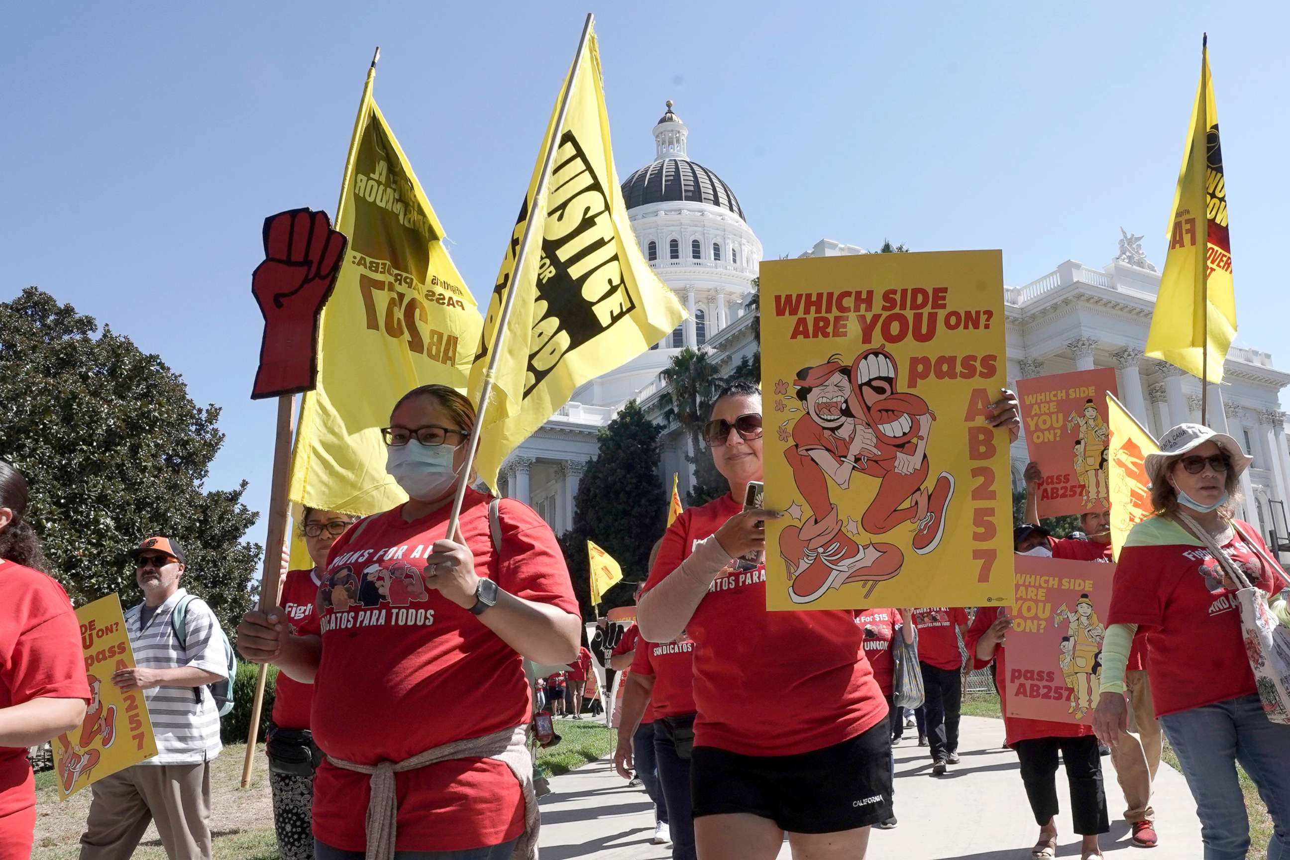 PHOTO: Fast food workers and their supporters march past the state Capitol calling on passage of a bill to provide increased power to fast-food workers, in Sacramento, Calif., Aug. 16, 2022. 