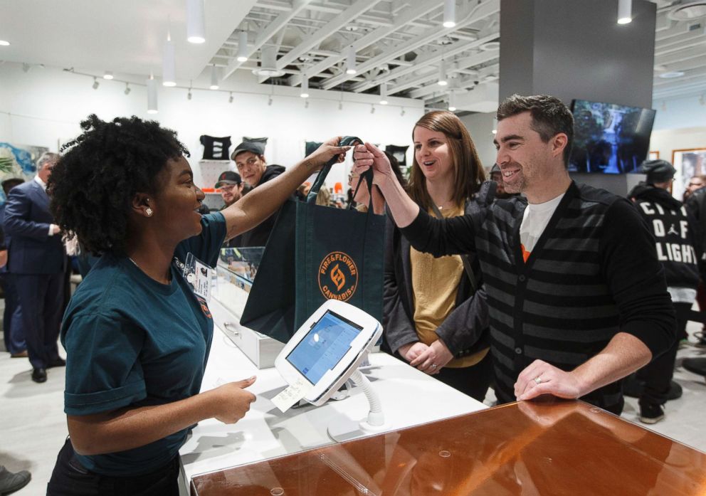 PHOTO: Curtis Hrdlicka is the first customer to purchase legal cannabis at Fire and Flower in Edmonton, Alberta, Oct. 17, 2018.