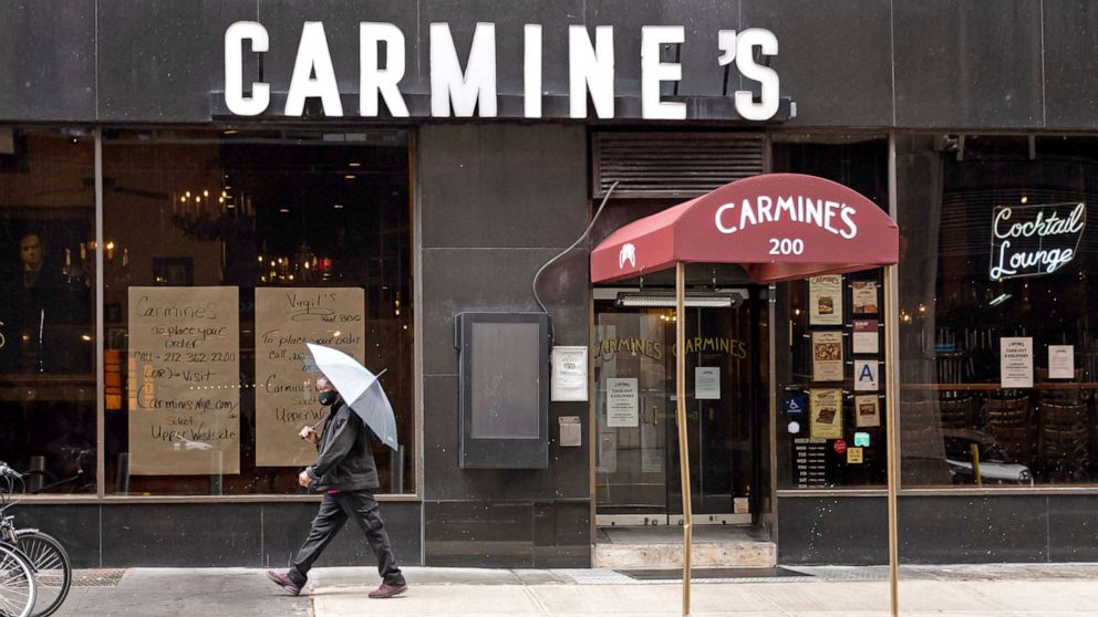 PHOTO: A person walks outside Carmine's Italian Restaurant in Times Square on Oct. 13, 2020 in New York City.