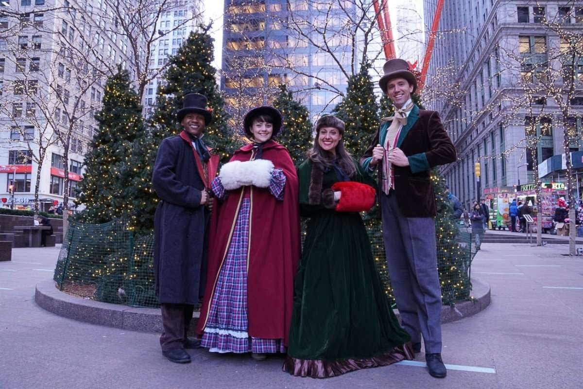 PHOTO: Erick Carter, Mallory Hawks, Natalie Storrs and Topher Lengerich perform carols as the "The Original Dickens Carolers."
