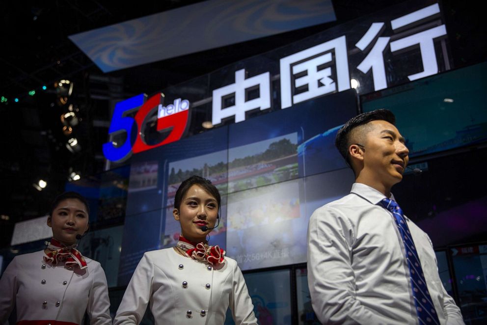 PHOTO: Staff members stand at a display for 5G services from Chinese technology firm China Telecom at the PT Expo in Beijing, Oct. 31, 2019.