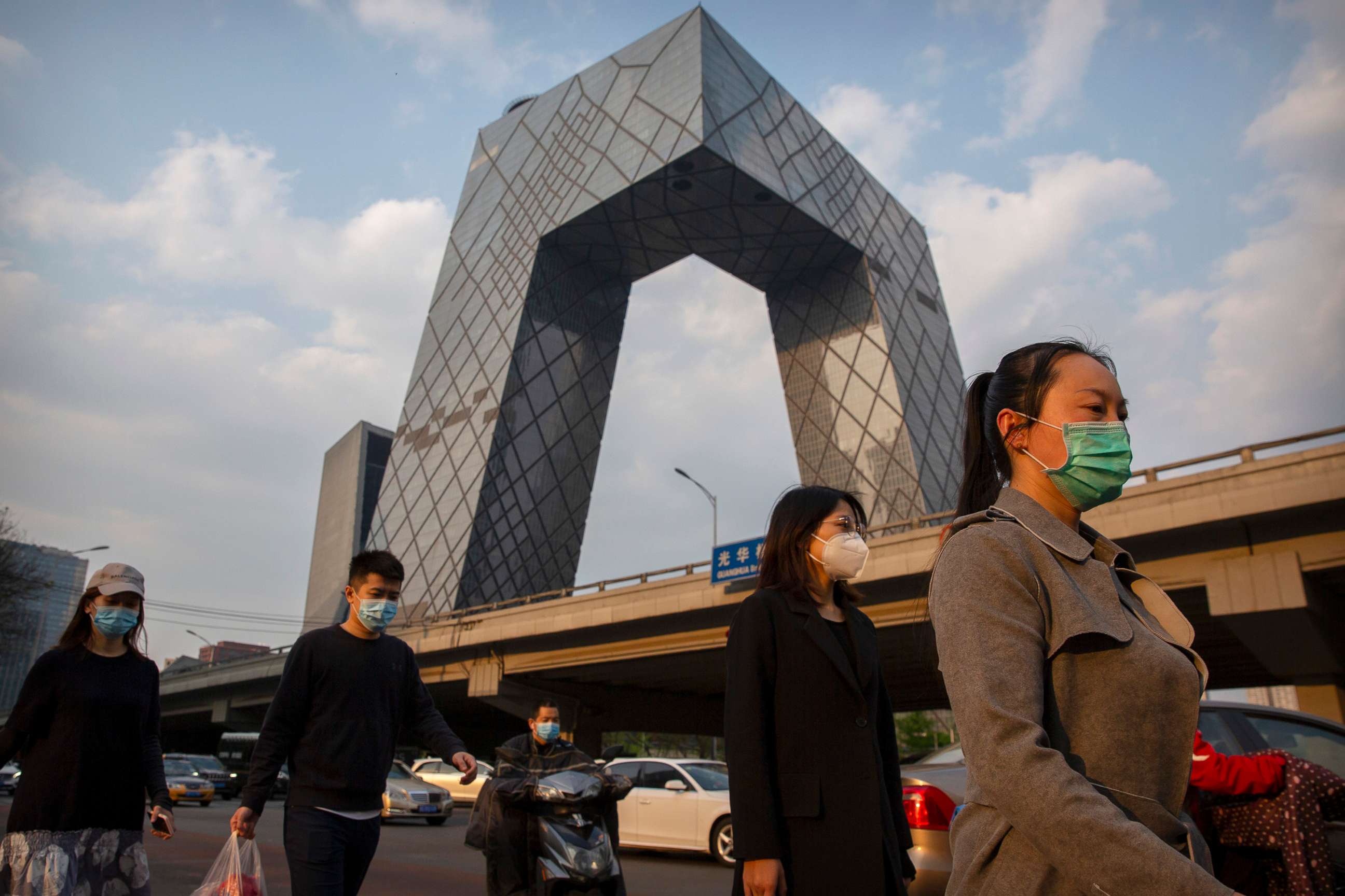 PHOTO: People walk through the central business district in Beijing, April 17, 2020. 