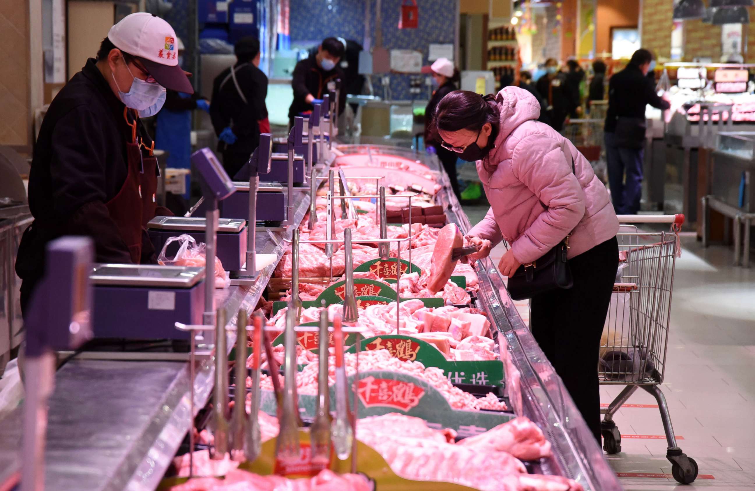 PHOTO: A consumer selects meat at a supermarket in Handan, north China's Hebei Province, April 10, 2020.