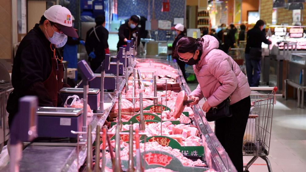 PHOTO: A consumer selects meat at a supermarket in Handan, north China's Hebei Province, April 10, 2020.