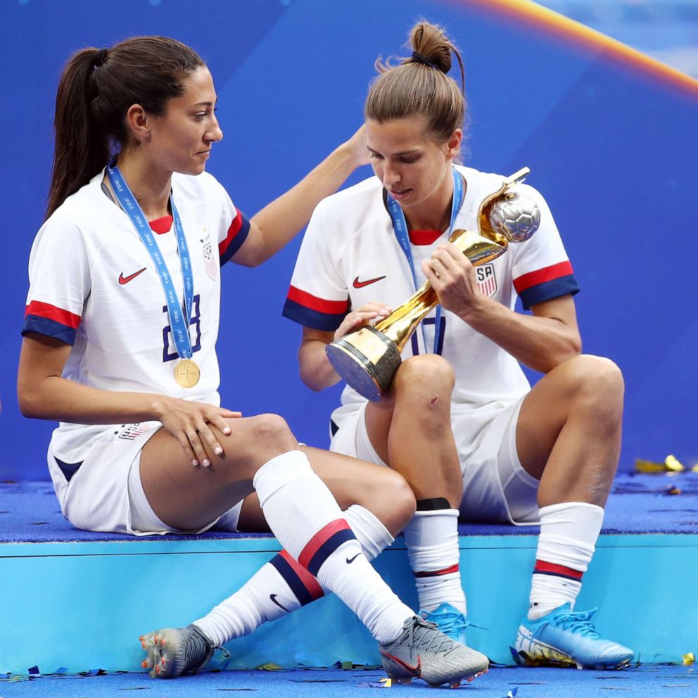 PHOTO: Tobin Heath and Christen Press celebrate with the FIFA Women's World Cup Trophy following the 2019 FIFA Women's World Cup France Final match between The U.S. and The Netherlands at Stade de Lyon on July 07, 2019, in Lyon, France.