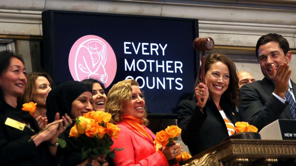 Christy Turlington,center, and employees of the non-profit organization Every Mother Counts, ring the closing bell of the New York Stock Exchange on April 29, 2016 in New York City. 