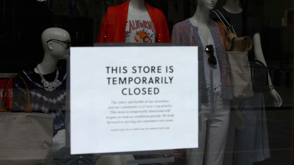 PHOTO: A sign is seen at the window of a closed store near Rockefeller Plaza on May 4, 2020 in New York City.