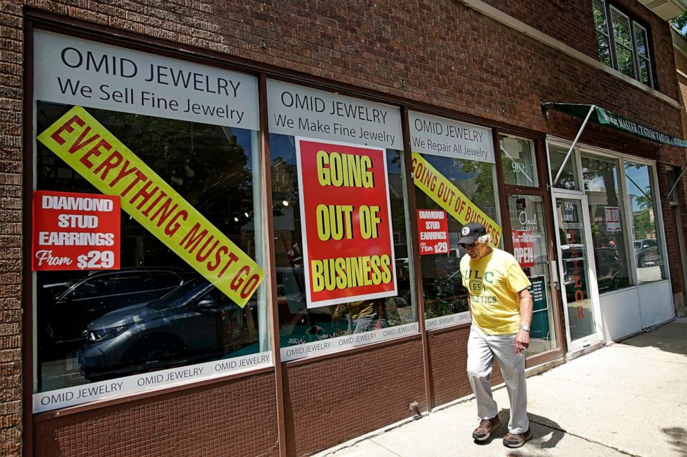 PHOTO: A man walks past a retail store that is going out of business due to the coronavirus pandemic in Winnetka, Ill., June 23, 2020. 