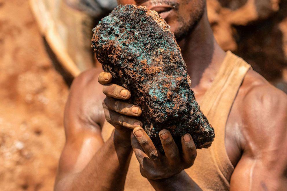PHOTO: Dela wa Monga, an artisanal miner, holds a cobalt stone at the Shabara artisanal mine near Kolwezi on Oct. 12, 2022.