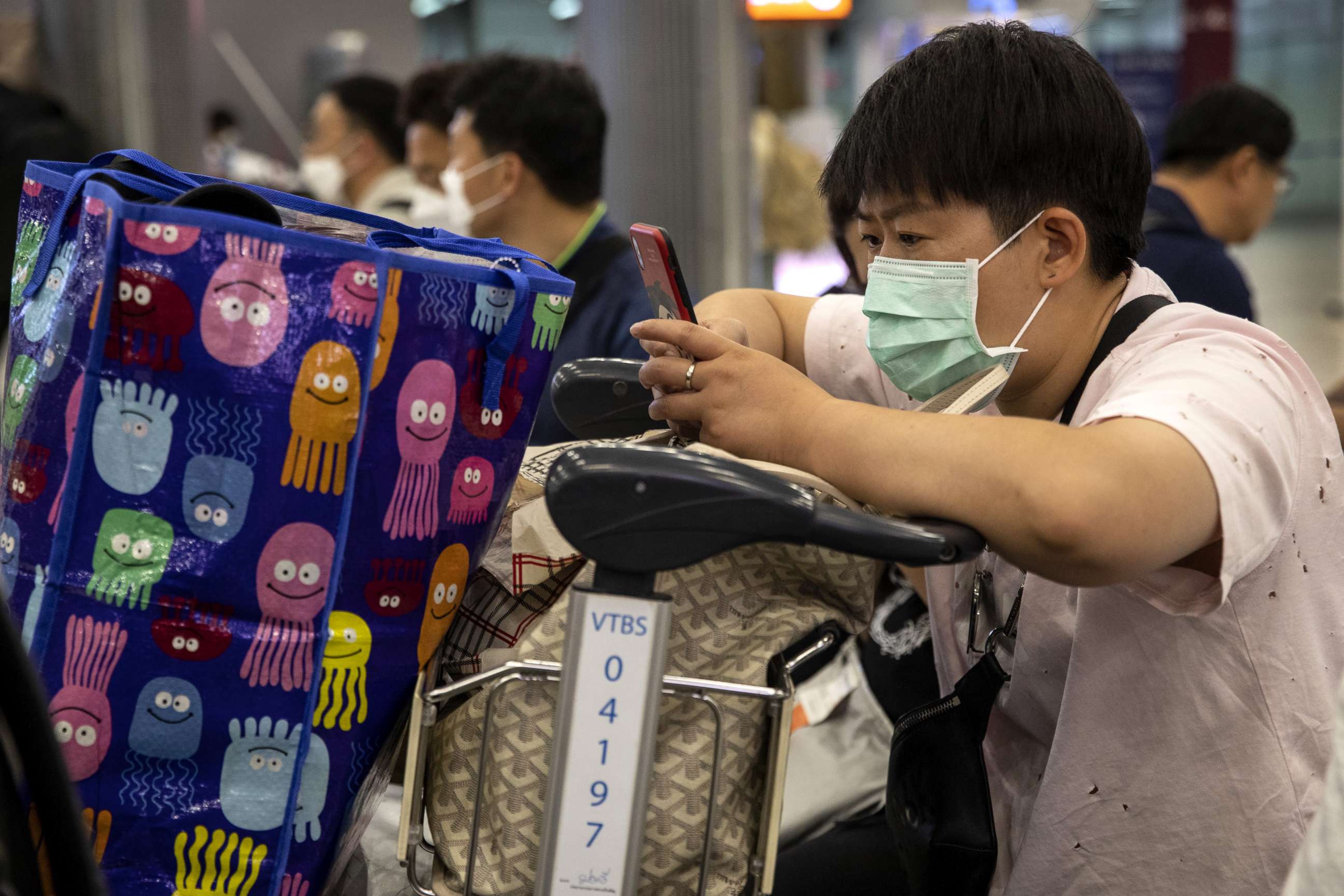 PHOTO: As Coronavirus spreads, a traveler wearing a mask checks his phone at Suvarnabhumi International airport in Bangkok, Thailand, Feb. 10, 2020.