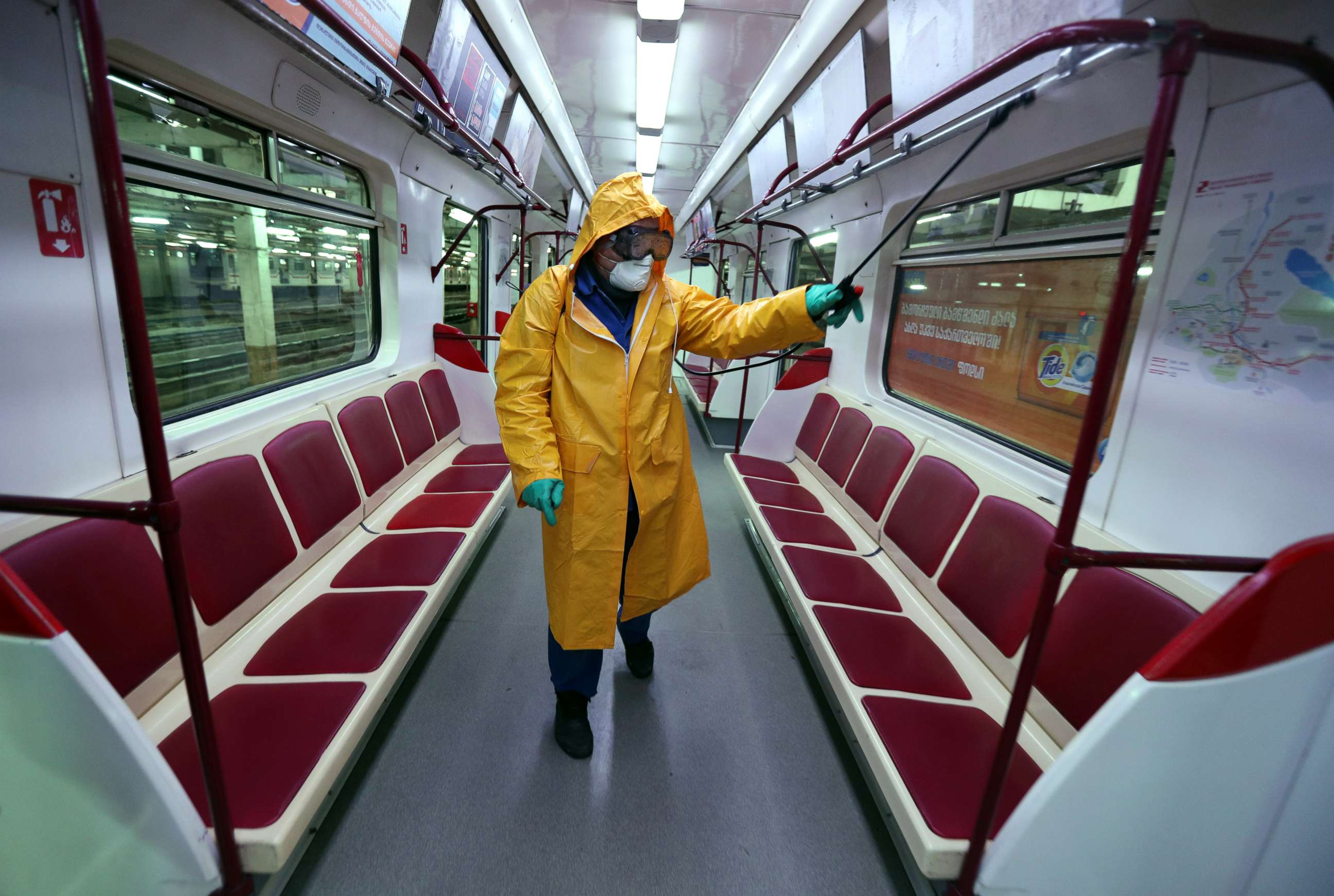 PHOTO: An employee wearing protective gear sprays disinfectant to sanitize a tube train over coronavirus fears in Tbilisi, Georgia, March 2, 2020.