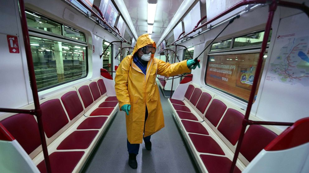 PHOTO: An employee wearing protective gear sprays disinfectant to sanitize a tube train over coronavirus fears in Tbilisi, Georgia, March 2, 2020.