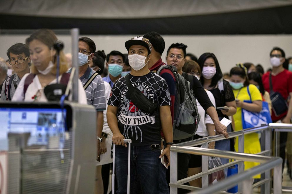 PHOTO: As Coronavirus spreads, travelers waiting in line at immigration wear masks at Suvarnabhumi International airport in Bangkok, Thailand, Feb. 10, 2020.