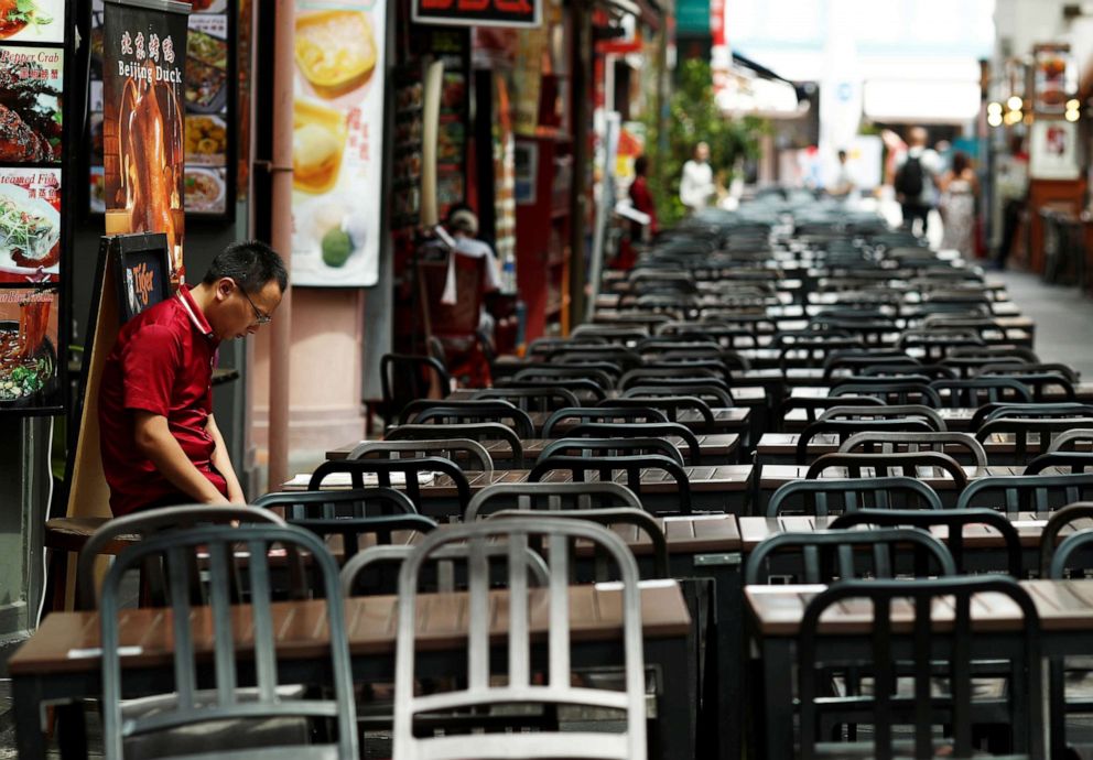 PHOTO: A restaurant promoter waits for customers at the largely empty Chinatown as tourism takes a decline due to the coronavirus outbreak in Singapore, Feb. 21, 2020.