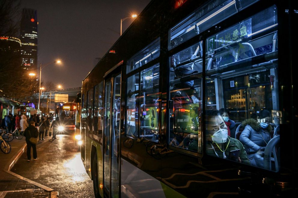 PHOTO: Chinese office workers wear protective masks as sit on a public bus after leaving work, March 2, 2020, in Beijing, China.