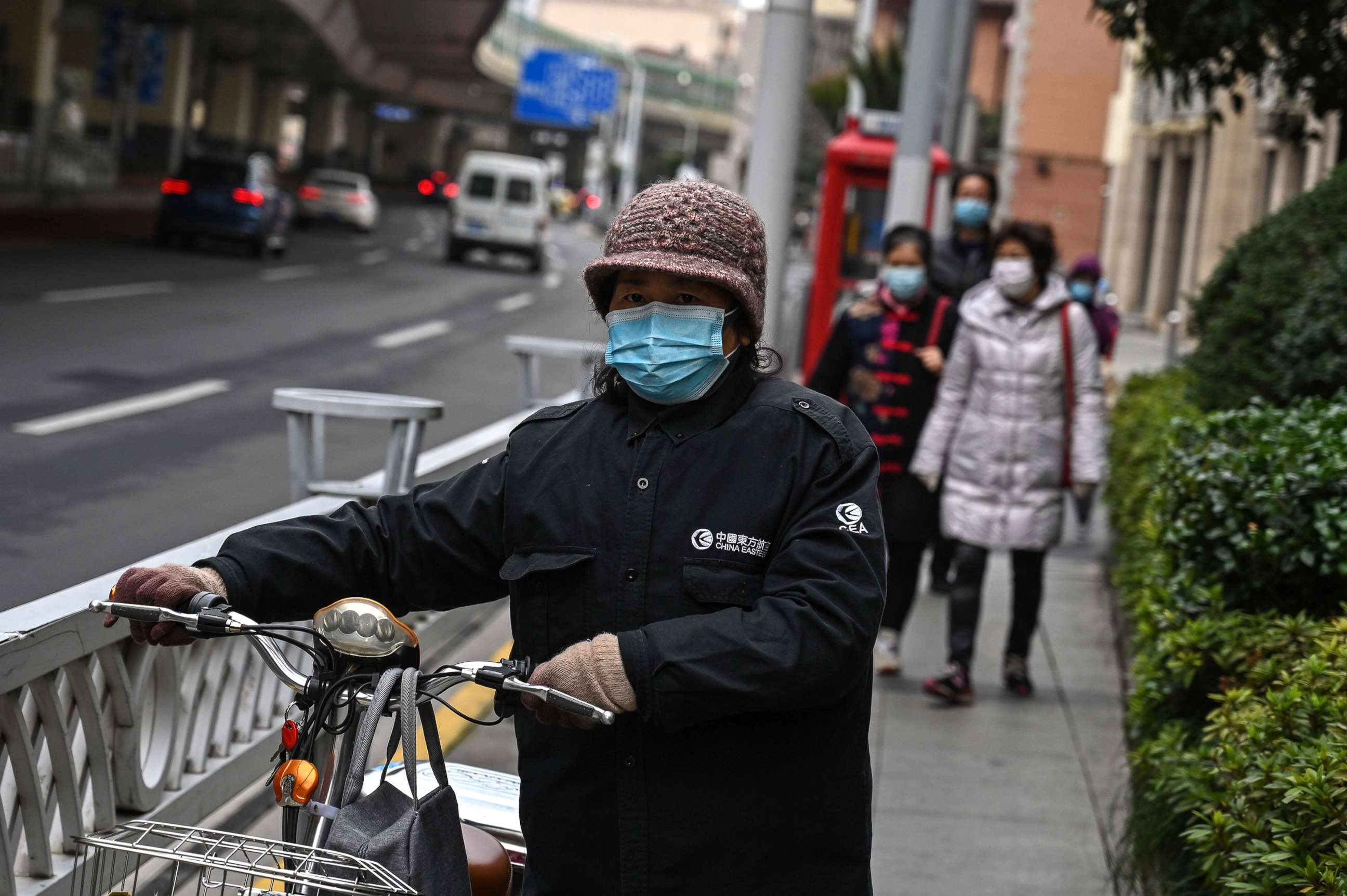 PHOTO:People wearing face masks walk on a street in Shanghai, March 3, 2020. 