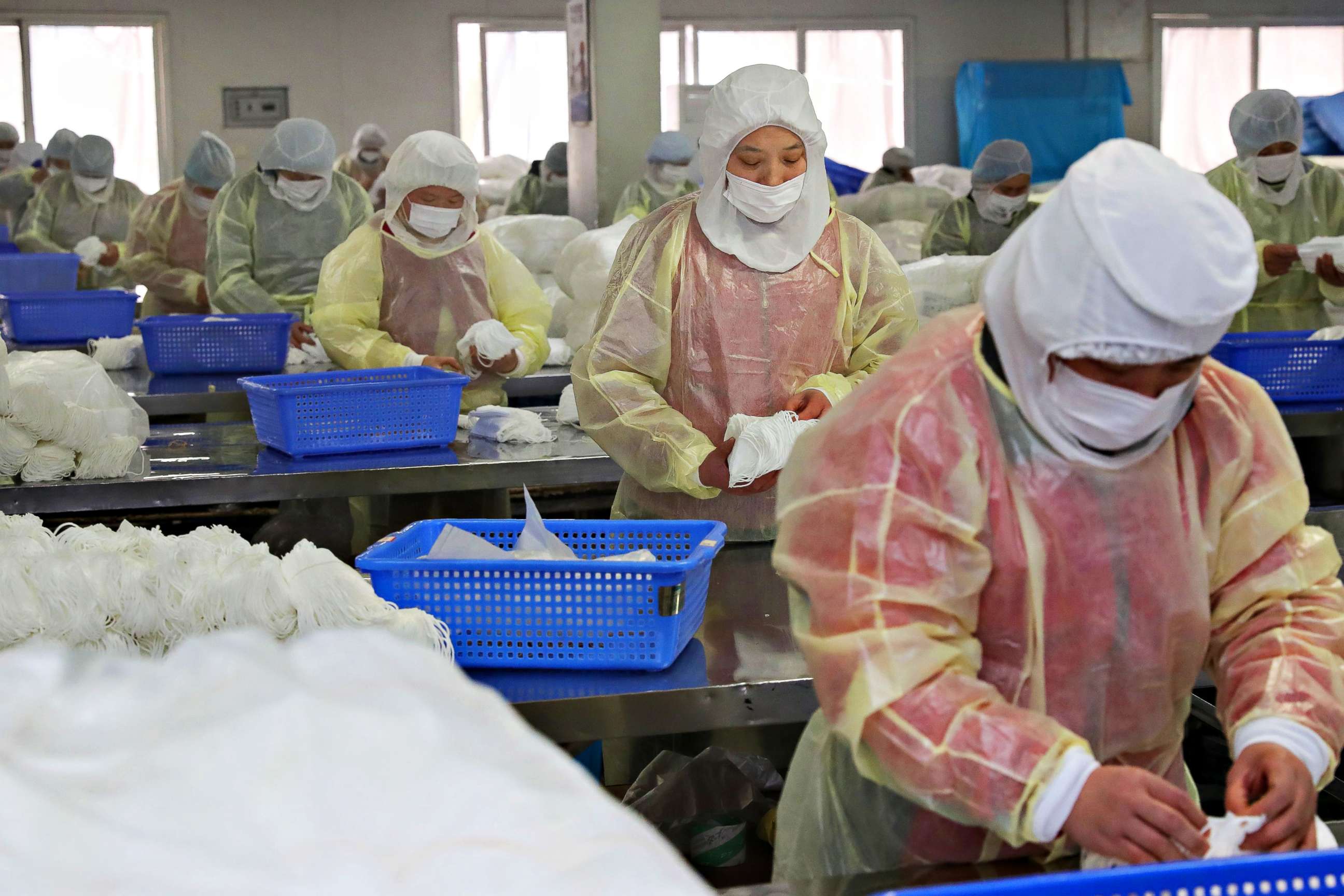PHOTO: Workers produce face masks at a factory in Nantong in China's eastern Jiangsu province on Jan. 27, 2020, to support the supply of medical materials during a deadly virus outbreak which began in Wuhan.