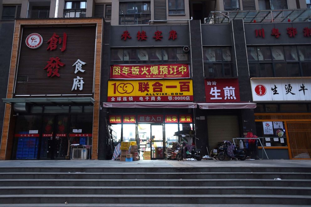 PHOTO: An open shop is seen between closed restaurants in Wuhan, the epicentre of the novel coronavirus outbreak, Hubei, China, Feb. 23, 2020.