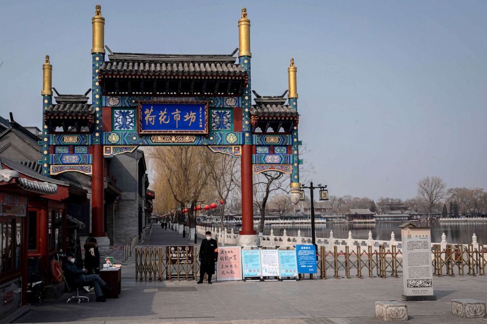 PHOTO: Security personel wearing facemasks to protect against the COVID-19 coronavirus secure an entrance to the Houhai lake which is closed off to the public in Beijing, China, Feb. 28, 2020.